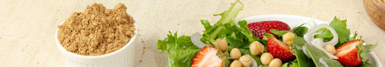 Brown sugar in a white bowl with a salad on a beige background
